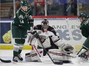 Goaltender Ryan Kubic of the Vancouver Giants makes a save against Riley Sutter of the Everett Silvertips on Dec. 27, 2017