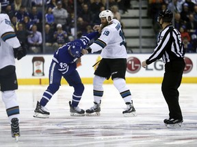 Toronto Maple Leafs' Nazem Kadri and San Jose Sharks' Joe Thornton drop the gloves after the opening faceoff at the Air Canada Centre on Jan. 4, 2018