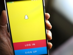 The Snapchat log-in page is displayed on a mobile phone.