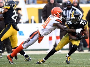 Sean Davis of the Pittsburgh Steelers is wrapped up for a tackle by Rashard Higgins of the Cleveland Browns after an interception in the second half during the game at Heinz Field on Dec. 31, 2017 in Pittsburgh, Pa. (Photo by Joe Sargent/Getty Images)