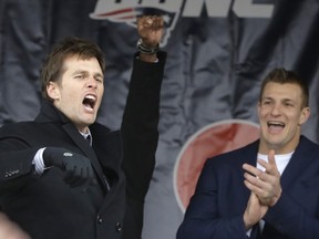 New England Patriots quarterback Tom Brady, left, shouts to the crowd as tight end Rob Gronkowski, right, applauds during an NFL football Super Bowl send-off rally, Monday, Jan. 29, 2018, in Foxborough, Mass. The Patriots are to play the Philadelphia Eagles in Super Bowl 52, Sunday, Feb. 4, in Minneapolis. (AP Photo/Steven Senne)