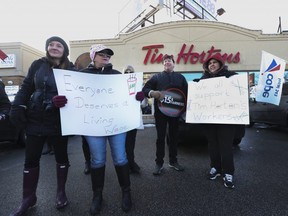 A large contingent of union members from the OSSTF, UNIFOR and other various groups showed up to rally and support Tim Hortons workers at an east-end Toronto location on Wednesday January 10, 2018. Jack Boland/Toronto Sun