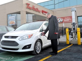 A Ford C-MAX Energi Plug-in Hybrid charges at Tim Hortons in Oakville after Tim Hortons launched its new electric vehicle charging station pilot in 2013. (CNW Group/Tim Hortons Inc.)