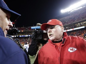 Tennessee Titans head coach Mike Mularkey, left, and Kansas City Chiefs head coach Andy Reid talk after their NFL wild-card playoff football game Saturday, Jan. 6, 2018, in Kansas City, Mo. (AP Photo/Charlie Riedel)
