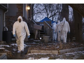 The Toronto Police Forensic Unit search a home at 53 Mallory Cres. (Stan Behal, Toronto Sun)