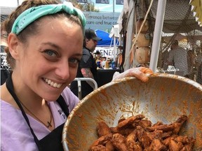 Brittany Brown of Windjammers spices up a bowl of wings at the 2017 National Buffalo Wing festival. In addition to the ultra popular annual festival, Buffalo is gaining a reputation as a go to place for foodies.