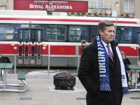 A near-empty streetcar passes Mayor John Tory at a press conference in support of the year-long King Street transit pilot on King St  W. in Toronto on Tuesday January 9, 2018. Veronica Henri/Toronto Sun