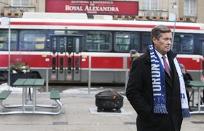 A near-empty streetcar passes Mayor John Tory at a press conference in support of the year-long King Street transit pilot on King St W. in Toronto on Tuesday January 9, 2018. Veronica Henri/Toronto Sun