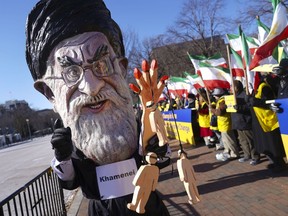 A demonstrator dressed as the Iranian Supreme Leader Ayatollah Ali Khamenei participates a rally across from the White House in Washington, on Saturday, Jan. 6, 2018, in solidarity with anti-government demonstrators in Iran. Iran has seen its largest anti-government protests since the disputed presidential election in 2009. (AP Photo/Pablo Martinez Monsivais)