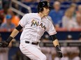 Christian Yelich of the Miami Marlins hits an RBI triple against the Colorado Rockies at Marlins Park on June 11, 2015