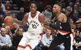 Raptors guard DeMar DeRozan drives to the basket on Portland Trail Blazers' Damian Lillard earlier this season. (AP PHOTO)