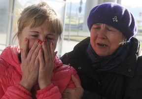 A Russian family shows their heartache after ISIS shot down an airliner over Egypt killing everyone aboard. GETTY IMAGES