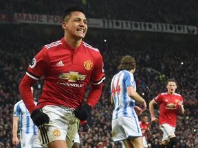 Manchester United's  Alexis Sanchez celebrates scoring 
against Huddersfield Town on Saturday. (GETTY IMAGES)