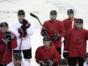 Members of Canada men's hockey team gather on the ice during a practice session on Friday. (AP PHOTO)