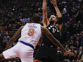 Raptors centre Jonas Valanciunas shoots over New York Knicks' Kyle O'Quinn during their game on Thursday.
 (STAN BEHAL/Toronto Sun)