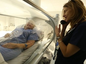 A nurse looks on as Karen (L) receives treatment at the Rouge Valley Hyperbaric Medical Centre. (JACK BOLAND, Toronto Sun)