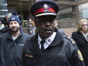 Toronto Police Chief  Mark Saunders comes out to speak to some cops' family members, who were protesting outside Toronto Police headquarters on Monday. (STAN BEHAL, Toronto Sun)