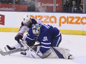 Maple Leafs goaltender Frederik Andersen Blue Jackets' Boone Jenner fight for the puck on Wednesday night.
 (VERONICA HENRI/Toronto Sun)