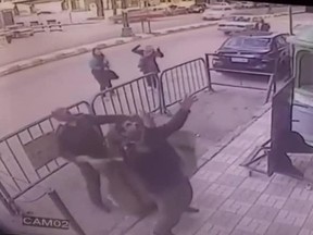 In this screenshot, three Egyptian policemen attempt to catch a five-year-old child before he falls from a third-floor apartment balcony in the southern city of Assiut on Feb 22, 2018.