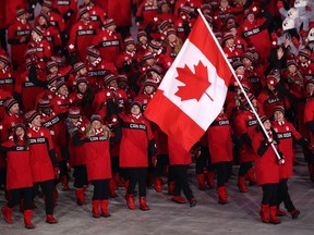The Canadian delegation, led by flag bearers Tessa Virtue and Scott Moir, marches into the opening ceremony at the Pyeongchang Olympics on Feb. 9.