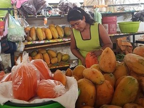 A woman slices fruit in the Puerto Escondido Mercado (market) Sarah Doktor/Postmedia Network
