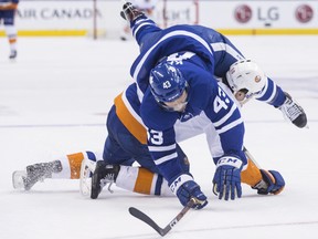 New York Islanders' Adam Pelech upends Leafs' Nazem Kadri during Thursday night's game.
 (THE CANADIAN PRESS)