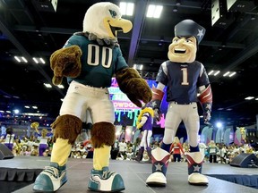 Philadelphia Eagles and New England Patriots mascots are seen onstage before the JoJo Siwa performs at Nickelodeon at the Super Bowl Expereince during NFL Play 60 Kids Day on January 31, 2018 in Minneapolis, Minnesota.