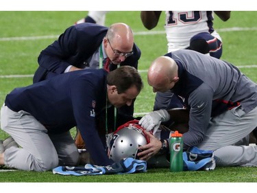 Brandin Cooks #14 of the New England Patriots is tended to by the trainers after sustaining an injury during the second quarter against the Philadelphia Eagles in Super Bowl LII at U.S. Bank Stadium on February 4, 2018 in Minneapolis, Minnesota.