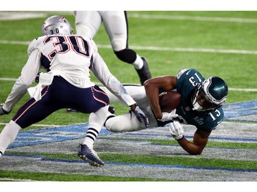 Alshon Jeffery #17 of the Philadelphia Eagles goes to the groundl against Duron Harmon #30 of the New England Patriots during the fourth quarter against the New England Patriots in Super Bowl LII at U.S. Bank Stadium on February 4, 2018 in Minneapolis, Minnesota.