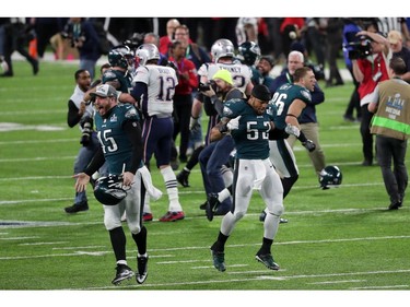 Rick Lovato #45 and Najee Goode #52 of the Philadelphia Eagles run on the field after defeating the New England Patriots in Super Bowl LII at U.S. Bank Stadium on February 4, 2018 in Minneapolis, Minnesota. The Philadelphia Eagles defeated the New England Patriots 41-33.