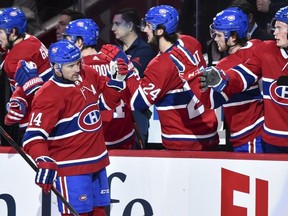 Tomas Plekanec #14 of the Montreal Canadiens celebrates his first period goal with teammates on the bench against the New York Rangers during the NHL game at the Bell Centre on February 22, 2018 in Montreal, Quebec, Canada.