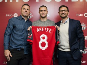 Ager Aketxe, poses for a photograph with TFC head coach Greg Vanney (left) and TFC general manager, Tim Bezbatchenko (right) after announcing that the TFC has signed Aketxe to the team, in Toronto, on Friday, February 23, 2018. THE CANADIAN PRESS/Christopher Katsarov