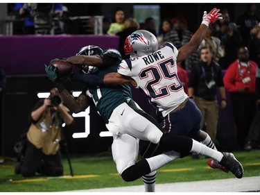 Alshon Jeffery (L) of the Eagles catches the ball in front of Eric Rowe of the Patriots to score a touchdown during Super Bowl LII between the New England Patriots and the Philadelphia Eagles at US Bank Stadium in Minneapolis, Minnesota, on February 4, 2018.