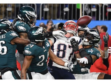 On the final play of the game, Rob Gronkowski of the New England Patriots is swarmed by the Philadelphia Eagles, failing to catch the long pass from Patriots quaterback Tom Brady (out of frame) during Super Bowl LII at US Bank Stadium in Minneapolis, Minnesota, on February 4, 2018. The Philadelphia Eagles scored a stunning 41-33 upset victory over the New England Patriots to win their first ever Super Bowl after a costly Tom Brady fumble ended the quarterback's tilt at history.