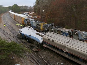 Authorities investigate the scene of a fatal Amtrak train crash in Cayce, South Carolina, Sunday, Feb. 4, 2018. At least two were killed and dozens injured. (Tim Dominick/The State via AP)