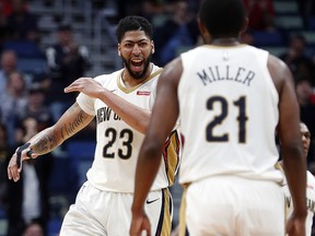 New Orleans Pelicans forward Anthony Davis (23) reacts after his slam dunk  against the Phoenix Suns in New Orleans, Monday, Feb. 26, 2018. (AP Photo/Gerald Herbert)