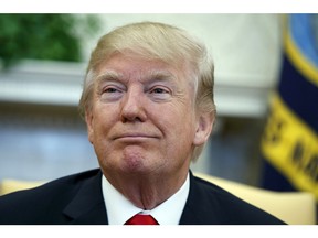 President Donald Trump speaks during a meeting with North Korean defectors where he talked with reporters about allowing the release of a secret memo on the FBI's role in the Russia inquiry, in the Oval Office of the White House, Friday, Feb. 2, 2018, in Washington.