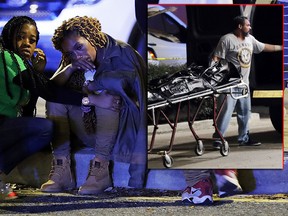 A woman is comforted as police investigate the scene of a Mardi Gras day shooting that left at least one dead and others injured, in the lower ninth ward in New Orleans, Tuesday, Feb. 13, 2018. (AP Photo/Gerald Herbert) ORG XMIT: LAGH207