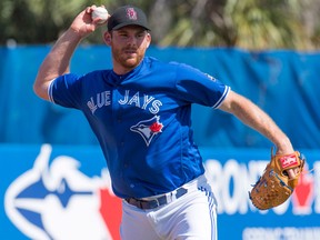 Toronto Blue Jays starting pitcher Joe Biagini throws out Philadelphia Phillies Cameron Rupp at first base during spring training action on Feb. 23, 2018