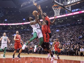 Boston Celtics Jaylen Brown (7) shoots on Toronto Raptors OG Anunoby (centre) and Serge Ibaka (right) during first half NBA basketball action in Toronto on Tuesday, February 6, 2018. THE CANADIAN PRESS