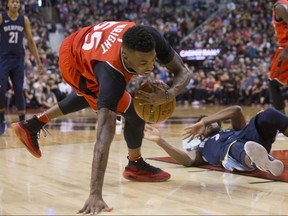 Toronto Raptors guard Delon Wright (55) collects a loose ball after wrestling with Memphis Grizzlies guard Wayne Selden on Sunday, February 4, 2018, at the ACC. THE CANADIAN PRESS/Chris Young