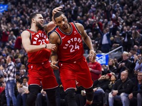 Raptors guard Fred VanVleet (23) congratulates teammate Norman Powell during a game against the  Timberwolves. THE CANADIAN PRESS/Christopher
