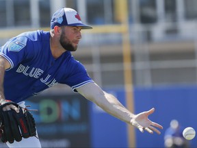 Toronto Blue Jays relief pitcher Tim Mayza does a fielding drill at spring training in Dunedin, Fla.
 (AP Photo/John Minchillo)