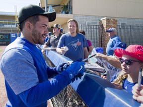 Toronto Blue Jays Devon Travis signs autographs following batting practice at spring training in Dunedin, Fla. on Friday February 23, 2018.