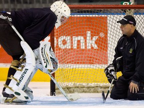 In this 2010 file photo, Igor Bobkov of Russia chats with Bill Dark, goalie coach for the London Knights
