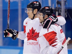 Rene Bourque, left, celebrates his goal with Canadian teammate Gilbert Brule during a game against Switzerland in Gangneung, South Korea on Feb. 15, 2018
