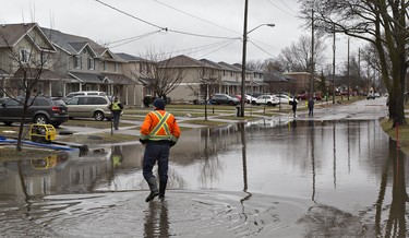 City of Brantford crews attempt to pump water from Grand River Street near Jarvis Street as storm drains have become overwhelmed. The city has declared a state of emergency as levels of the Grand River have risen significantly and are expected to peak at 2:00 p.m. today, and several areas of the city are being evacuated. Brian Thompson/Brantford Expositor/Postmedia Network