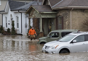 Grand River Street at Scarfe Avenue is flooded as storm drains have become overwhelmed in Brantford, Ontario. The city has declared a state of emergency as levels of the Grand River have risen significantly and are expected to peak at 2:00 p.m. today, and several areas of the city are being evacuated. Brian Thompson/Brantford Expositor/Postmedia Network