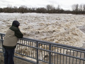 Onlookers watch the raging waters of the Grand River at Wilkes Dam in Brantfor on Wednesday, Feb. 21, 2018. Brian Thompson/Brantford Expositor/Postmedia Network ORG XMIT: POS1802211723232004