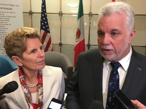 Premier Kathleen Wynne and Premier Philippe Couillard speak to reporters after an event at the Washington international trade association in Washington, D.C., , Friday, Feb.23, 2018. THE CANADIAN PRESS/Alex Panetta